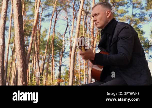 String Instruments Hd Portrait of smiling caucasian artist plays wooden acoustic guitar in ...