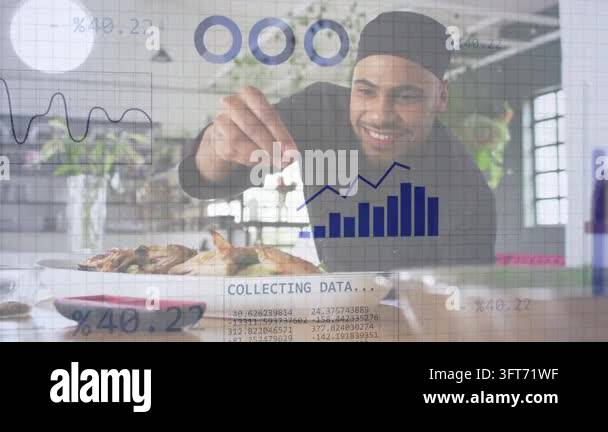Man leaning and sprinkling garnish at kitchen table activating waveform ...