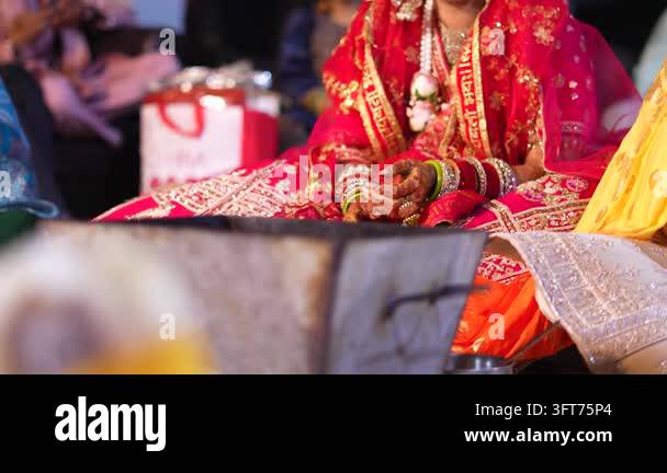 Red Indiand Close up of an Indian bride in traditional red attire participating in ...