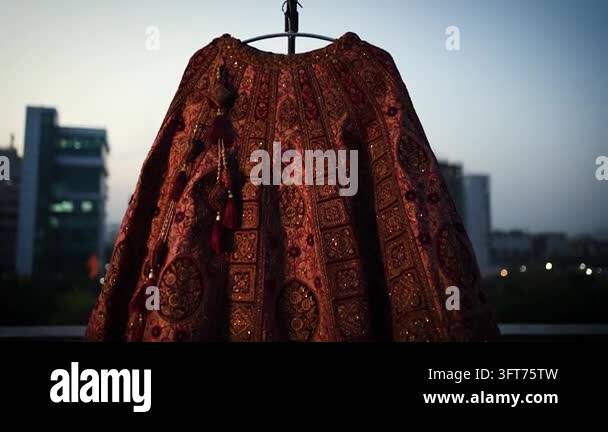 Red Indiand A traditional red Indian wedding lehenga skirt displayed outdoors ...