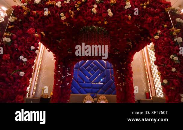 Red Indiand A vibrant red rose floral archway set up for an Indian wedding ceremony ...