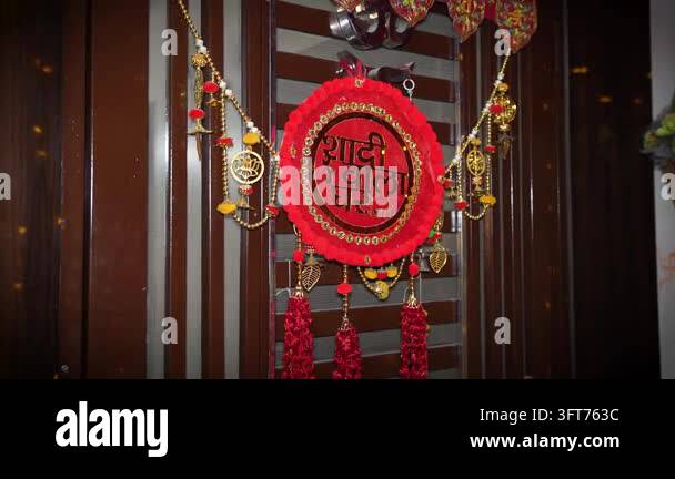 Red Indiand A decorative red floral sign hanging on a door for an Indian wedding ...