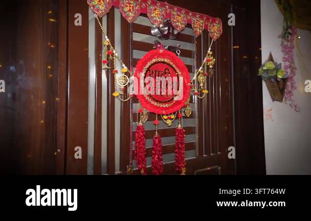 Red Indiand A decorative red floral toran hanging on a residential door for an ...
