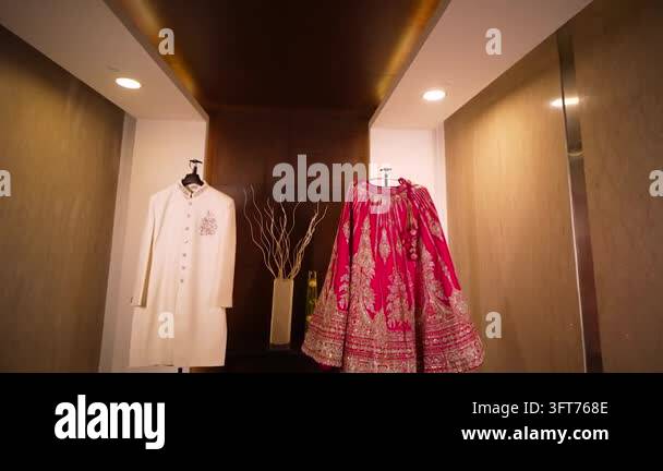 Red Indiand A formal display of a white sherwani and red lehenga for an Indian ...