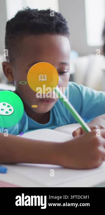 Animation of school icons over busy african american schoolboy working ...