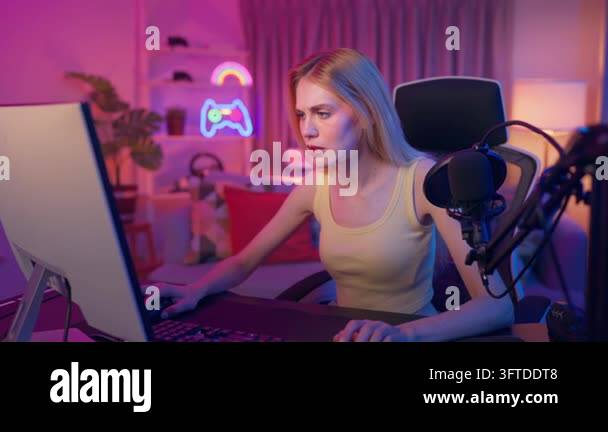 Wwhile A frustrated woman gamer reacts intensely while playing a video game in ...