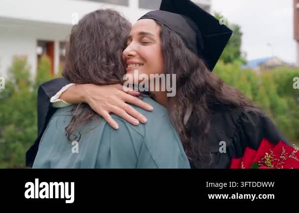 Red Roses Fixtures A smiling woman in a graduation cap and gown hugs another person ...