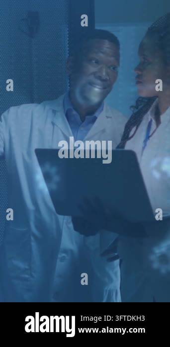 Vertical video: Two lab techs pointing at glass, initiating projected ...