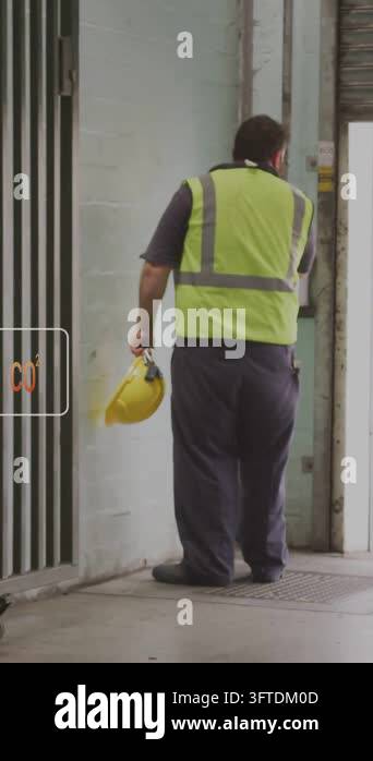 Vertical video: Warehouse worker at shutter, pressing control box and ...