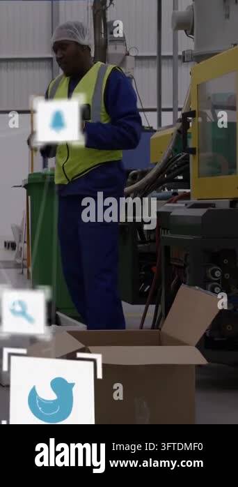 Scanning operator in yellow vest checking scanner at plant line, with ...