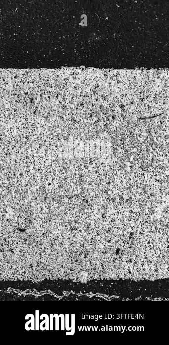 Close up of a contrasting asphalt texture showing rough grey aggregate ...