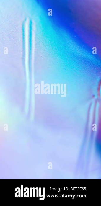 An abstract, iridescent texture with shimmering blue and purple colors ...
