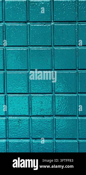 Close up abstract view of a textured aqua mosaic wall tile pattern with ...