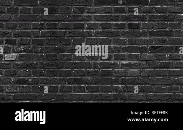 A detailed, rough, dark gray brick wall texture pattern with visible ...