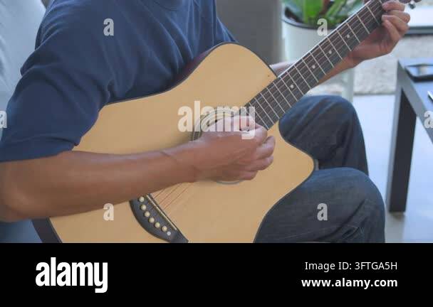 String Instruments Hd The musician practices chords on a wooden string instrument while ...