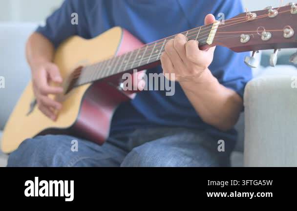 String Instruments Hd The musician practices chords on a wooden string instrument while ...