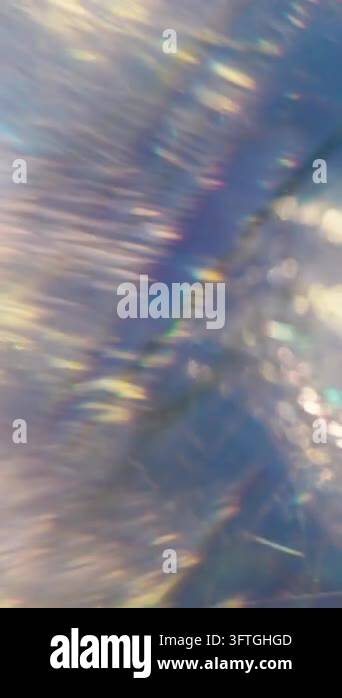 Vertical video. Defocused light overlay. Shimmering glow. Crackled ice ...