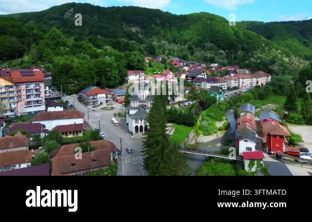 Aerial view depicting small town nestled in green mountain valley ...