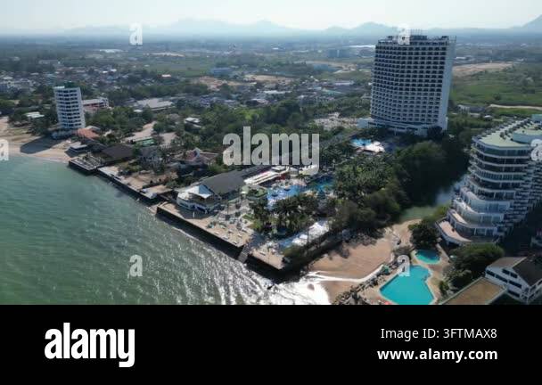 Aerial view showing coastal resort complex featuring high-rise hotel ...