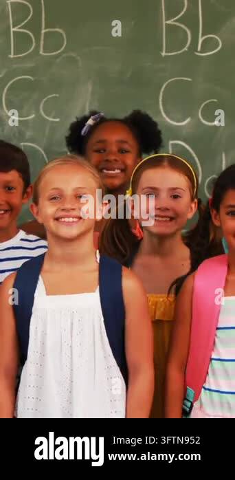 Animation of falling icons over diverse schoolkids in class at school ...