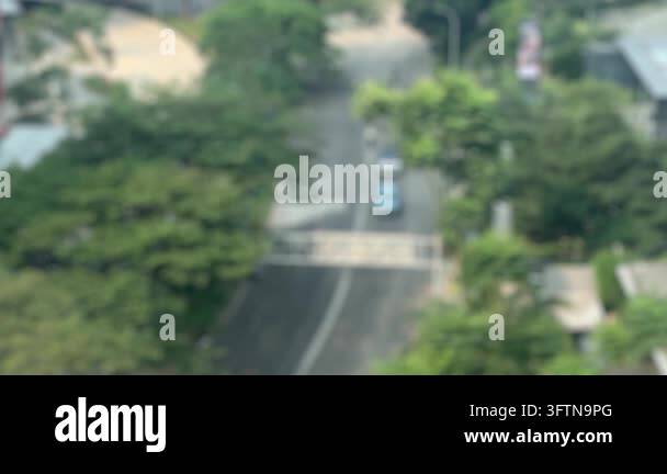 Vertical aerial view of blurred cars and motorcycles moving along a ...