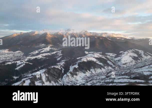 Snowy mountains under cloudy sky during sunset Stock Video Footage - Alamy