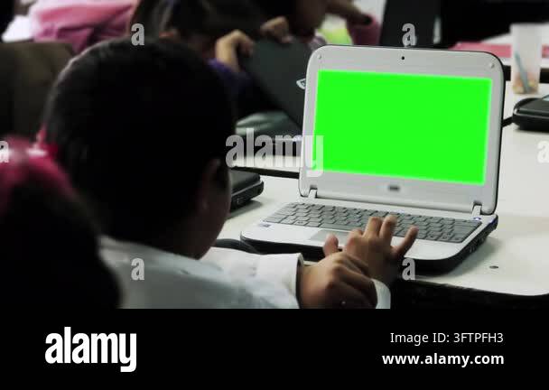 Unrecognizable Elementary Student Using Small Laptop with Green Screen ...