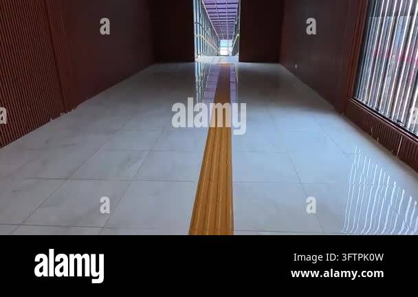 First-person Video of Long glass walkway leading to train station ...
