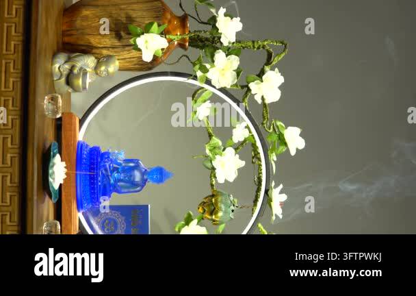 Decorative arrangement of white flowers on a circular frame with a blue ...