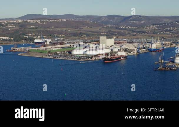 Aerial view of a busy shipping port with cargo containers and cranes ...