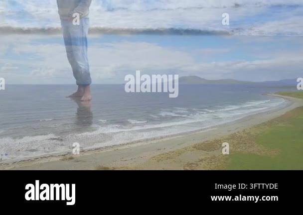 Fading in, man in light-gray hoodie, blue jeans stepping onto sandy ...