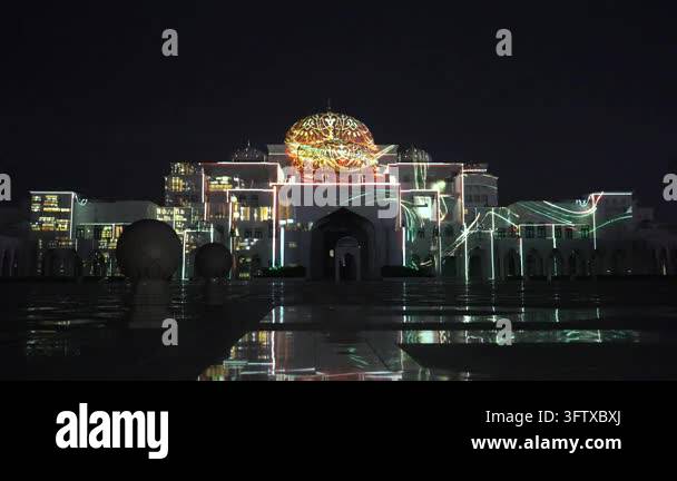 Wide shot of a building at night with a light projection show ...