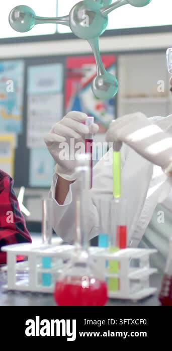 Scientist demonstrating experiment to children over molecular structure ...