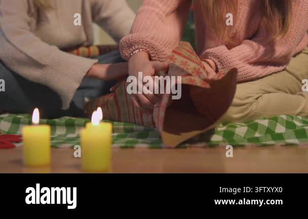 Close Friend Vector Friends wrap a present together on the floor beside warm candles during ...
