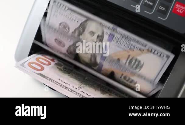 Hundred dollar bills flipped by cash counting machine on table slow ...