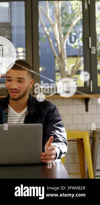 Vertical video: Man using laptop cafe left tech alerts icons and lines ...