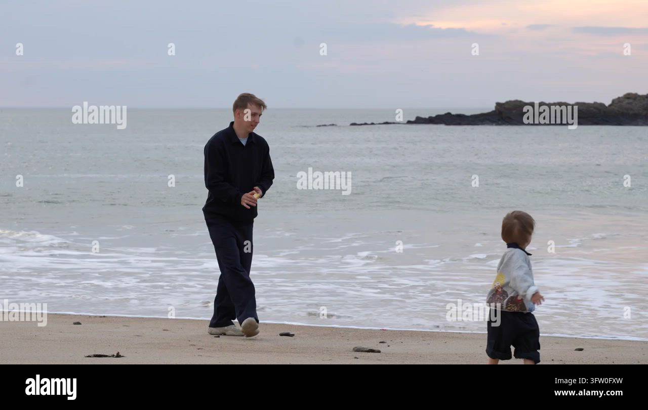 father running after toddler son on beach at sunset Stock Video Footage ...