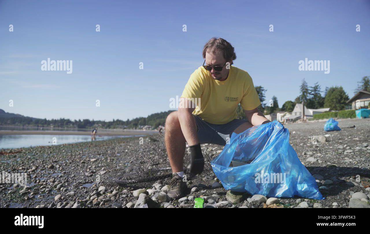 Man cleaning beach with net and bicycle salvage, candid Stock Video ...