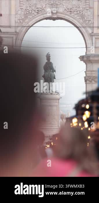People walking on a busy street with the famous rua augusta arch ...
