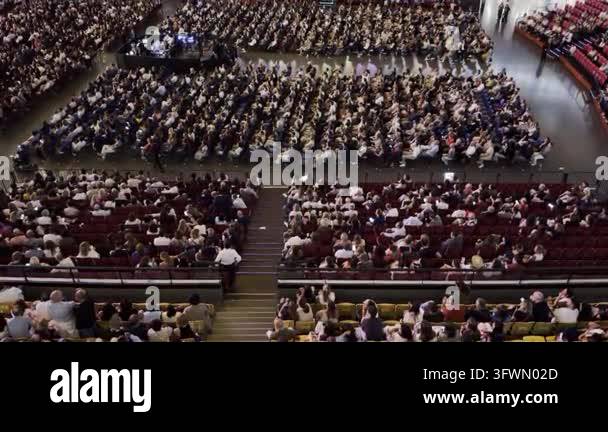 Samminar Images High-angle view of a crowd of people listening to a speaker at a ...