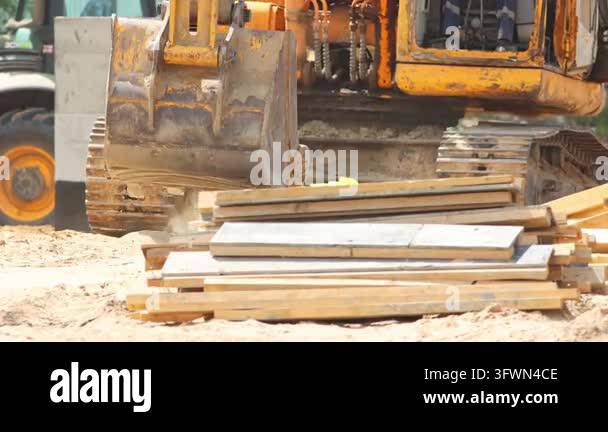 Heavy machinery excavator moving sand and dust on a building site ...