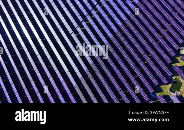 Reflection Image Bright Vast solar panel array spans open field. Overhead drone of countless ...