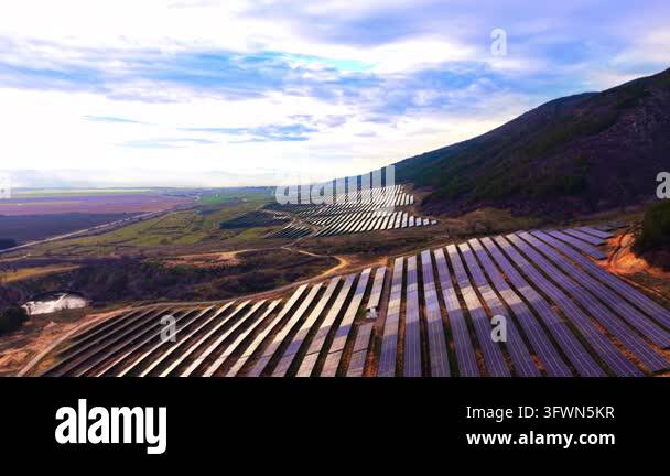 Expansive solar farm nestled in mountain valley. Elevated aerial view ...