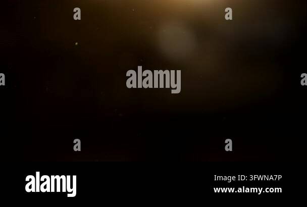 Reflection Image Bright Bright golden light flare emerging from darkness with subtle circular ...