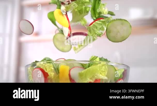 Pepper Hd Fresh vegetable salad falling into glass bowl with lettuce sliced ...