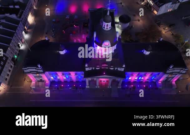 Aerial drone footage capturing a historic building illuminated with ...