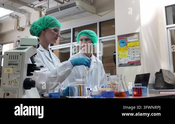 Microscopes Laboratory room. Female scientists conducting laboratory research with ...