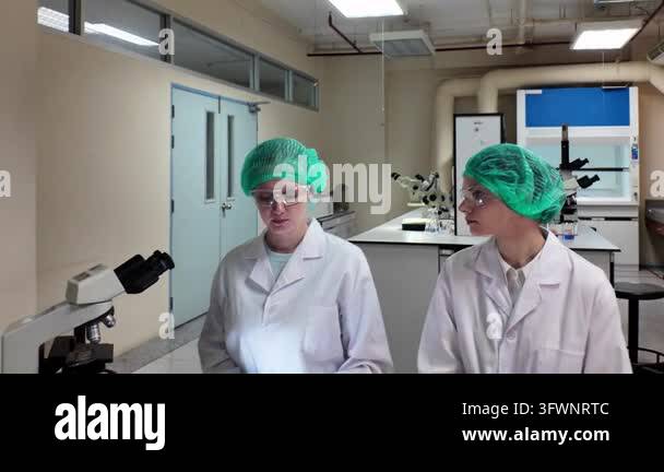 Microscopes Laboratory room. Female scientists conducting laboratory research with ...