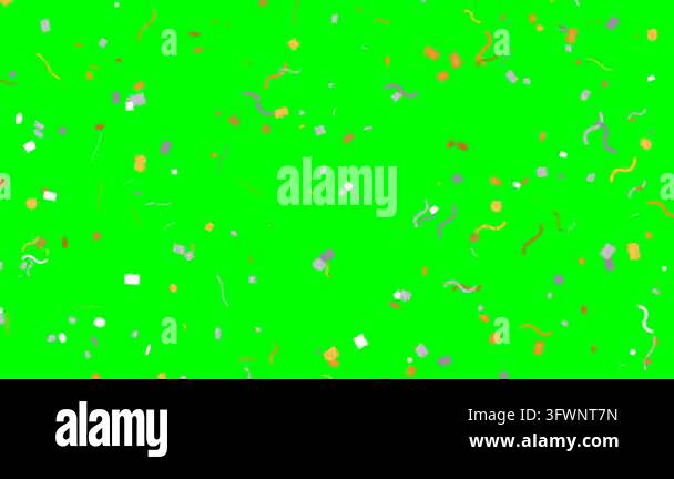 Colorful confetti pieces fall rapidly against a solid green screen ...