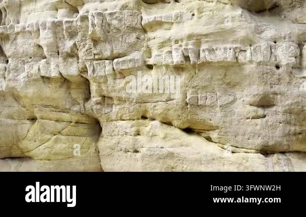 Hand touching natural sandstone rock wall texture in a canyon. Close-up ...